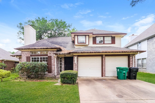 view of front of home with a garage and a front lawn