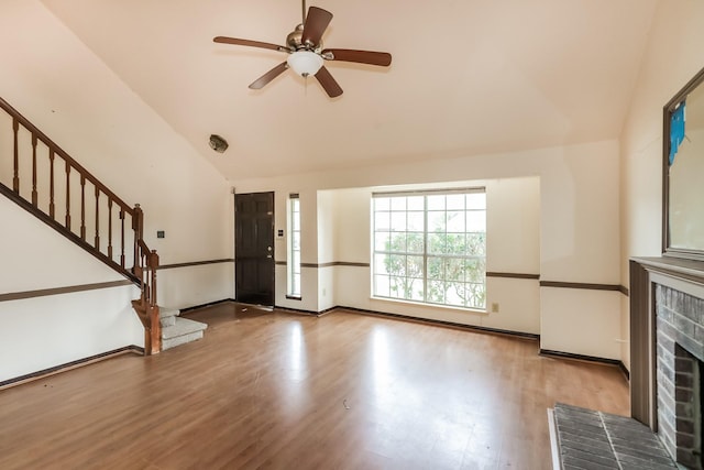 unfurnished living room featuring a fireplace, hardwood / wood-style flooring, ceiling fan, and lofted ceiling