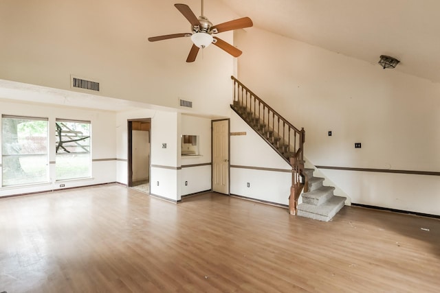 unfurnished living room with ceiling fan, light hardwood / wood-style flooring, and high vaulted ceiling