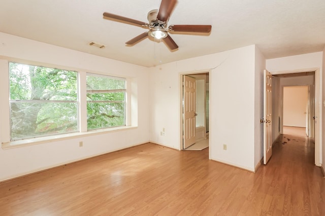 unfurnished bedroom featuring ceiling fan and light wood-type flooring