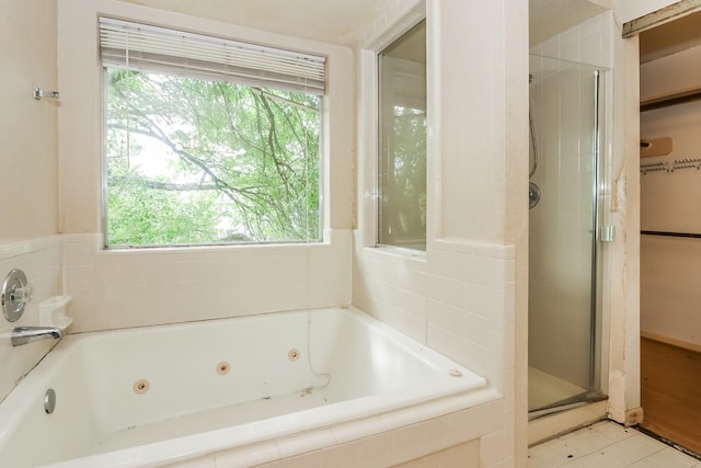 bathroom with tile patterned floors and independent shower and bath