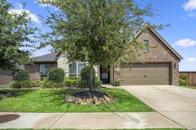 view of front of home with a garage and a front lawn