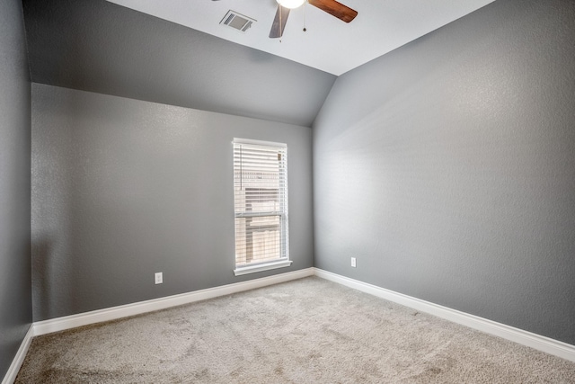 spare room with carpet flooring, ceiling fan, and lofted ceiling