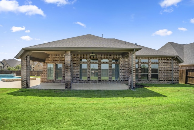 back of property with a patio, ceiling fan, and a lawn