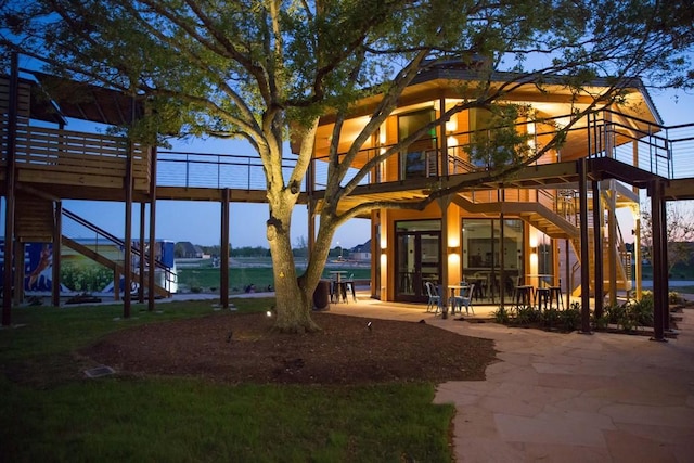 exterior space featuring a deck with water view and a patio