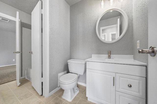 bathroom featuring visible vents, toilet, a textured ceiling, vanity, and a textured wall