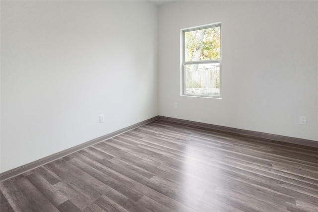 unfurnished room with wood-type flooring