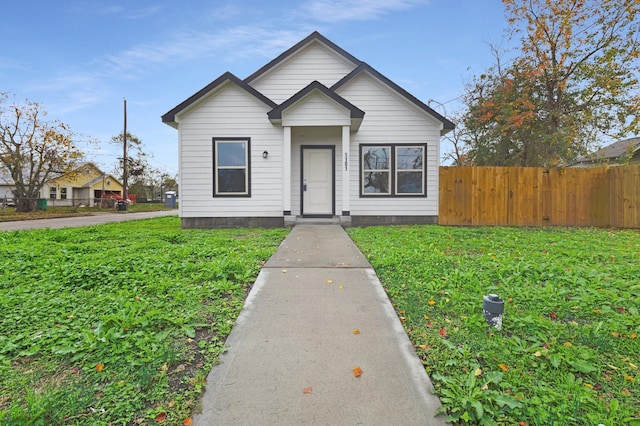 bungalow-style home featuring a front yard