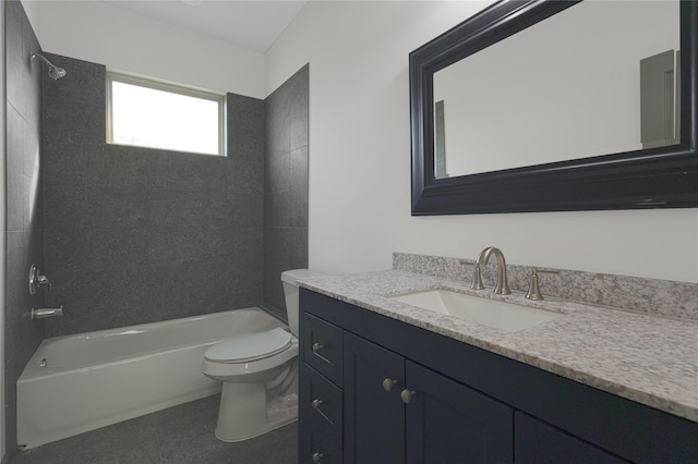 full bathroom featuring vanity, tiled shower / bath combo, and toilet