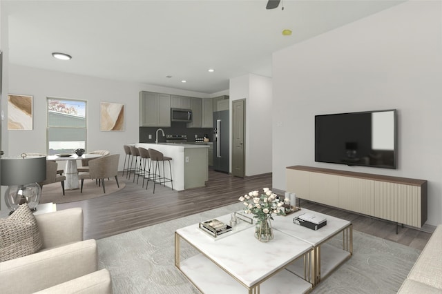 living room featuring dark hardwood / wood-style floors, ceiling fan, and sink