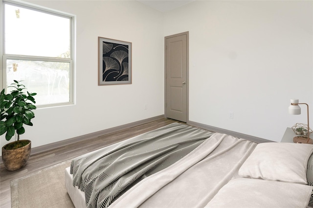 1101 Johnson St, Baytown, TX 77520 - bedroom with baseboards and wood finished floors
