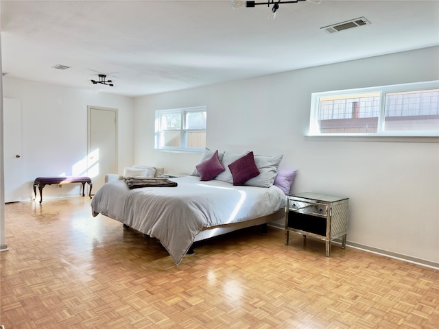 bedroom with baseboards and visible vents