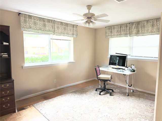 office area featuring baseboards and a ceiling fan