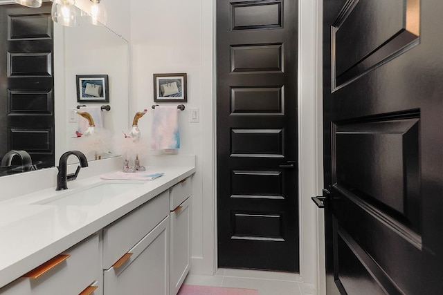 bathroom with tile patterned flooring and vanity