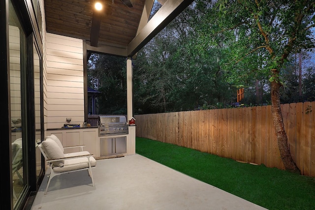 view of patio featuring area for grilling and a grill