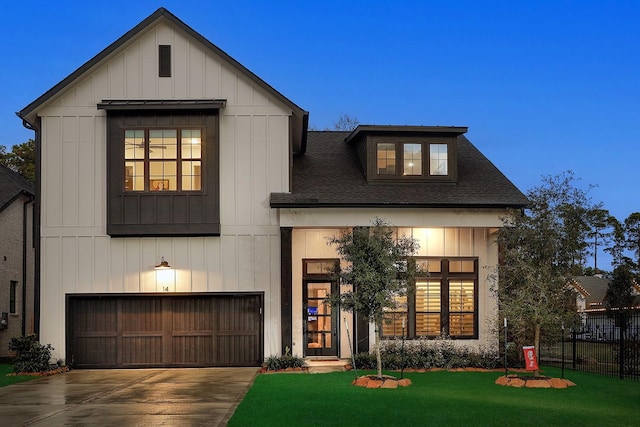 view of front of home with a yard and a garage