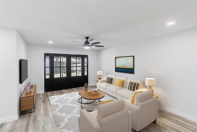 living room featuring ceiling fan and light wood-type flooring