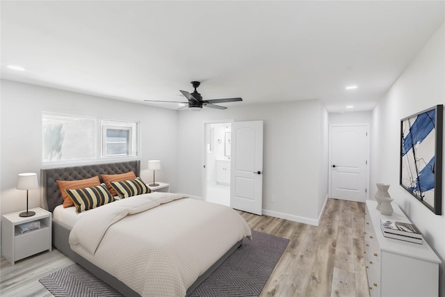 bedroom with ceiling fan, ensuite bathroom, and light wood-type flooring