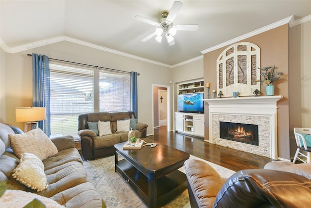 living room featuring vaulted ceiling, ceiling fan, hardwood / wood-style flooring, and ornamental molding