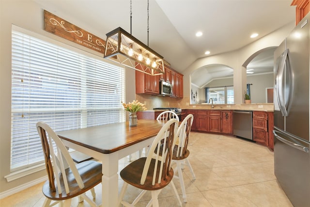 dining space featuring light tile patterned floors and lofted ceiling