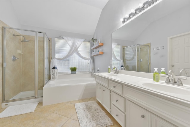 bathroom featuring tile patterned flooring, vanity, separate shower and tub, and vaulted ceiling