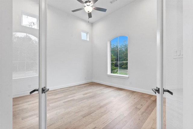 unfurnished room with ceiling fan, french doors, and light hardwood / wood-style floors