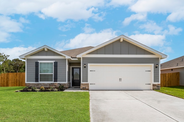 view of front of property featuring a garage and a front yard