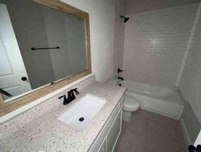 full bathroom with tile patterned flooring, vanity, toilet, and tiled shower / bath