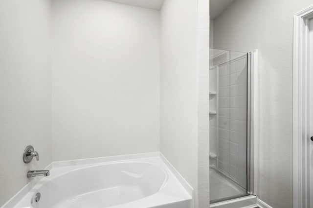 bathroom featuring shower with separate bathtub