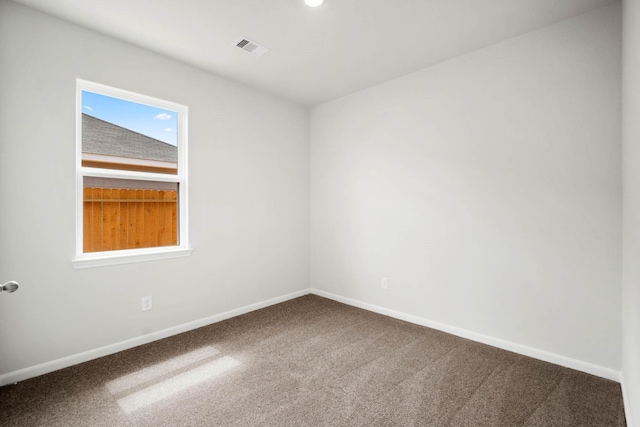 carpeted spare room with vaulted ceiling