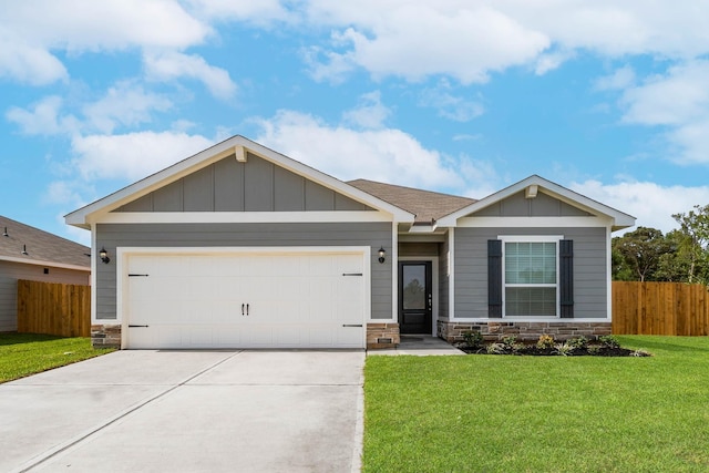 view of front of home with a front yard and a garage