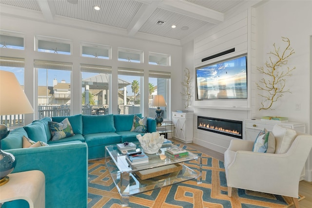 living room with beam ceiling, crown molding, coffered ceiling, and hardwood / wood-style floors