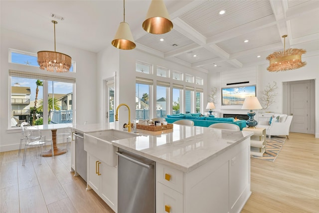 kitchen with white cabinetry, dishwasher, and hanging light fixtures