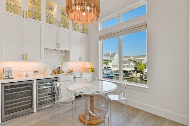 bar with beverage cooler and white cabinetry