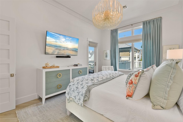 bedroom with access to exterior, light parquet floors, a chandelier, and ornamental molding