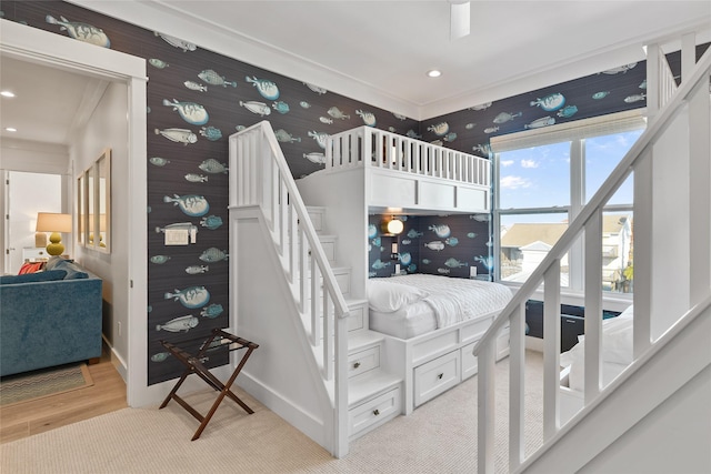 staircase featuring crown molding and hardwood / wood-style flooring