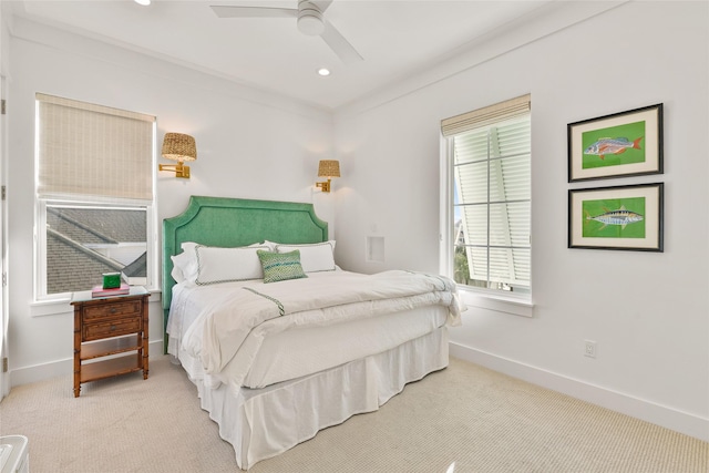 carpeted bedroom featuring ceiling fan, ornamental molding, and multiple windows