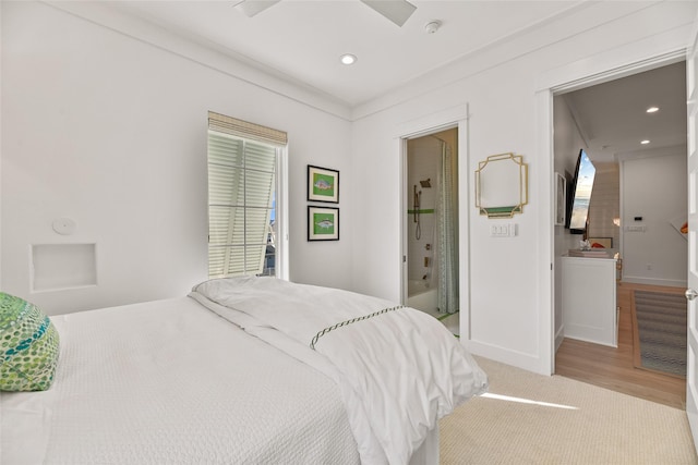 bedroom with ensuite bathroom, ceiling fan, ornamental molding, and light hardwood / wood-style flooring