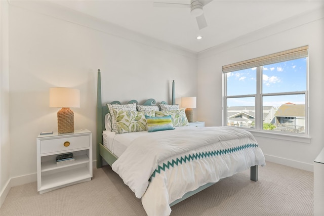 bedroom featuring ceiling fan, ornamental molding, and light carpet