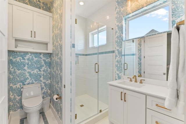 bathroom featuring a shower with shower door, tile patterned floors, toilet, and vanity