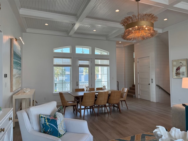 dining area with dark hardwood / wood-style floors, beamed ceiling, coffered ceiling, and a chandelier