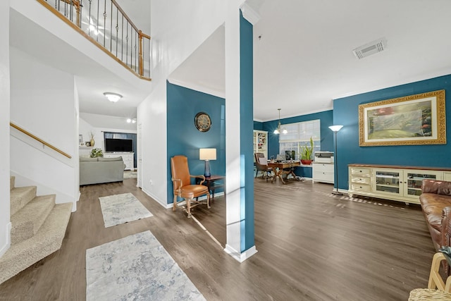 foyer featuring wood-type flooring, a high ceiling, and an inviting chandelier