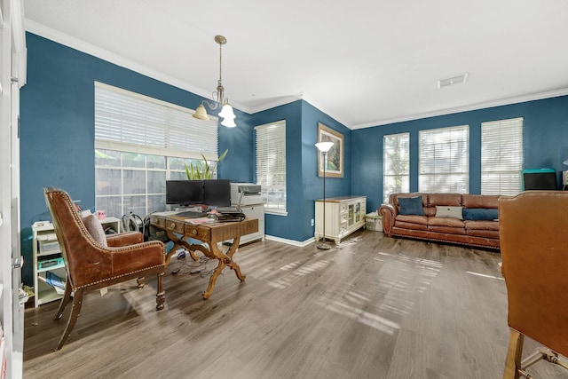 interior space featuring hardwood / wood-style flooring, ornamental molding, and a notable chandelier