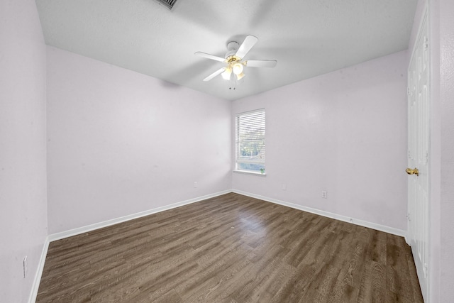 unfurnished room featuring dark hardwood / wood-style floors and ceiling fan