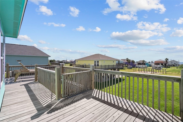 wooden terrace featuring a lawn