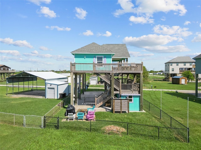 view of jungle gym with an outbuilding, a yard, and a deck