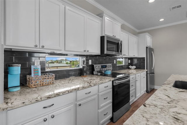 kitchen featuring stainless steel appliances, dark hardwood / wood-style floors, backsplash, crown molding, and white cabinets