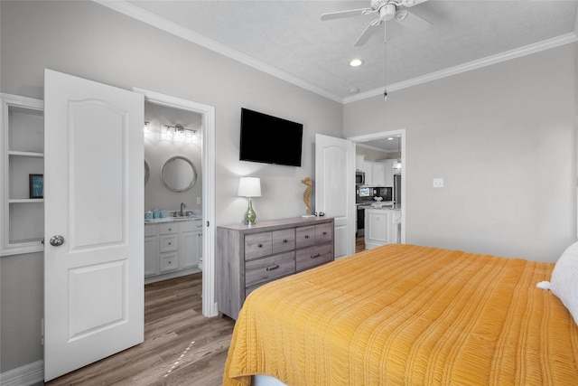 bedroom with ensuite bathroom, ceiling fan, crown molding, sink, and light hardwood / wood-style flooring