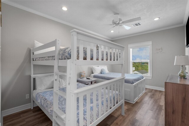 bedroom with a textured ceiling, dark hardwood / wood-style floors, ceiling fan, and crown molding