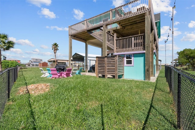 back of house featuring a lawn and a deck